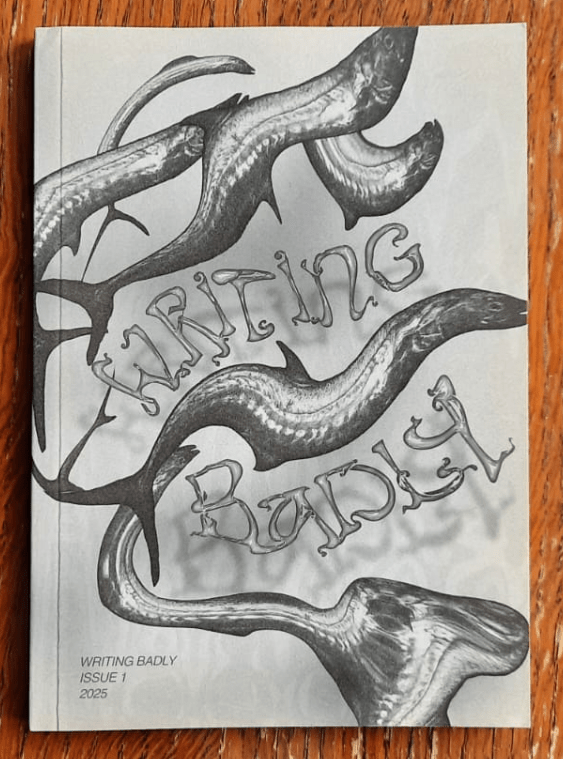 Photo of Writing Badly Issue 1. The cover image is greyscale and features an abstract image of several fish.